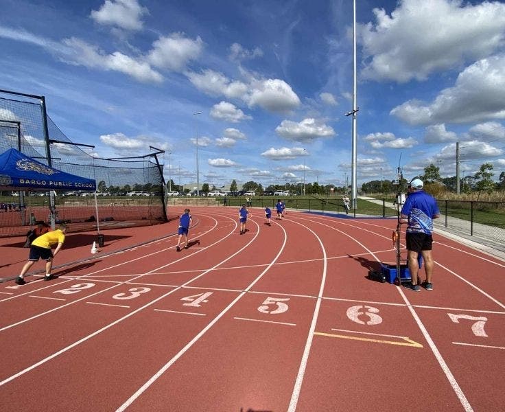 Students racing on an athletics field